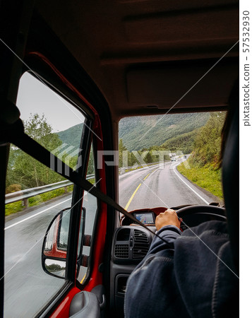 Image from passenger compartment of car driving along road among green trees in Norway on summer. Image from passenger compartment of car driving along road among green trees in Norway on summer. 57532930