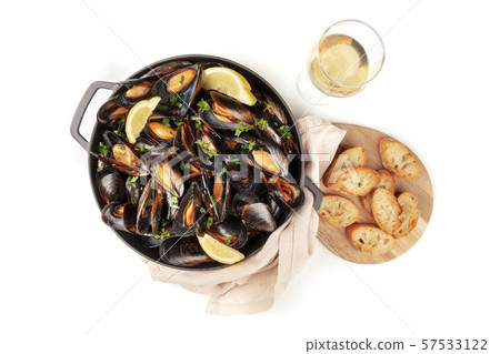 Marinara mussels, moules mariniere, shot from above in a cooking pan with toasted bread and a glass 57533122