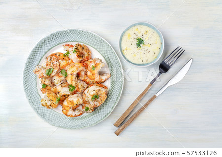 Fried shrimps with Caesar sauce, top shot on a wooden background with copyspace 57533126