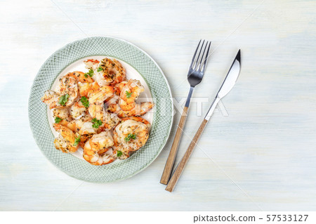 Fried shrimps, overhead shot on a rustic wooden background with a place for text 57533127