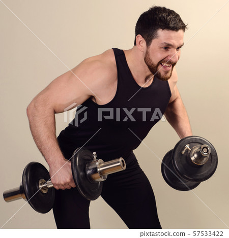 A young athlete performs an exercise with A young athlete performs an exercise with 57533422