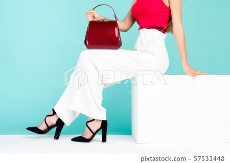 Beautiful legs woman sitting on the bench. With Beautiful legs woman sitting on the bench. With 57533448