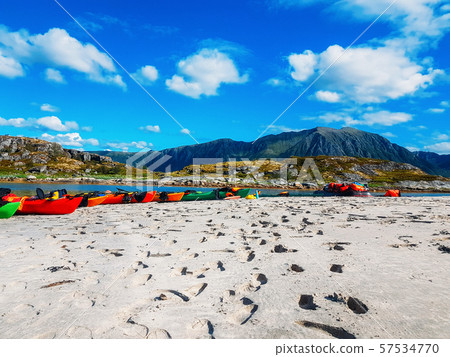 Photo of norway with sea, beach, cloudy sky, colorful boats on summer 57534770