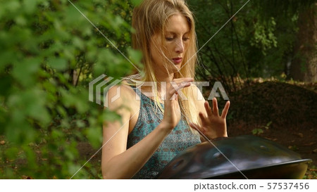 Playing The Instrument Hung. Woman Hands Playing The Hang outdoors. 57537456