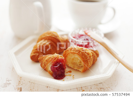 Coffee and croissant with strawberry jam 57537494