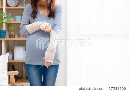 Pregnant woman wearing arm warmer Pregnant woman wearing arm warmer 57538500