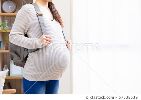 Pregnant woman going out Pregnant woman going out 57538539