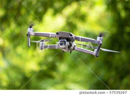 Flying drone with camera hovering Flying drone with camera hovering 57539267