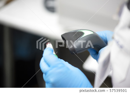 Bar code scanner and test tube over monitor Bar code scanner and test tube over monitor 57539501