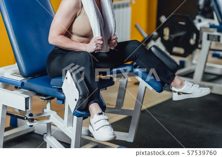 Beautiful sport girl is engaged on a simulator in the gym. Pretty girl with the beautiful tightened Beautiful sport girl is engaged on a simulator in the gym. Pretty girl with the beautiful tightened 57539760