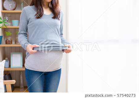 Pregnant woman wearing stomach wrap 57540273