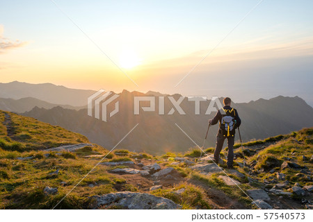 Successful active man hiker on top of mountain Successful active man hiker on top of mountain 57540573