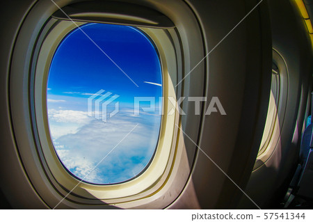 Clouds and sky seen from airplane window Clouds and sky seen from airplane window 57541344