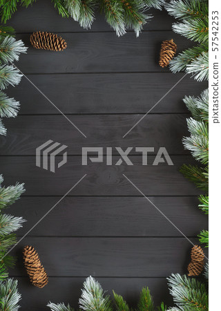 Christmas or New Year decoration background: fir-tree branches, colorful balls, candy cane on black background. Top view with copy space. Falt lay. Christmas or New Year decoration background: fir-tree branches, colorful balls, candy cane on black background. Top view with copy space. Falt lay. 57542253