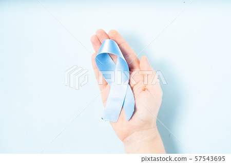 Hand holding Diabetes Awareness Blue Ribbon Hand holding Diabetes Awareness Blue Ribbon 57543695