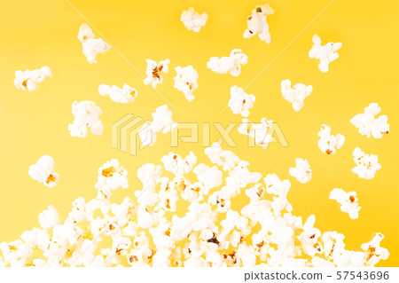 Scattered popcorn over yellow background Scattered popcorn over yellow background 57543696