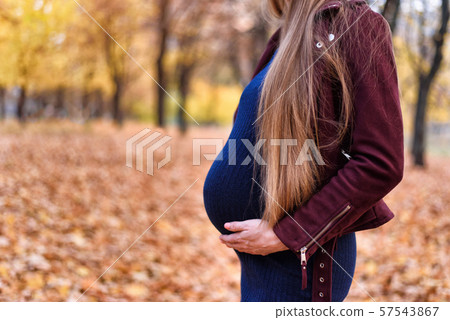 Belly of a pregnant woman with hands. Eighth 57543867