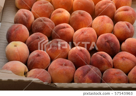 Fresh ripe peaches in paper box close-up. Fresh ripe peaches in paper box close-up. 57543963