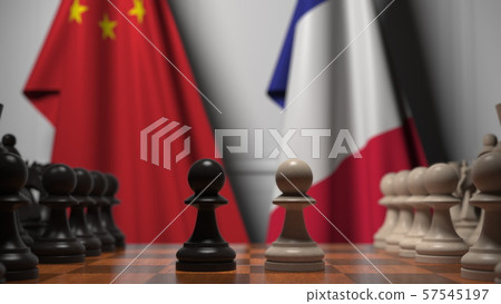 Flags of China and France behind chess board. The first pawn moves in the beginning of the game 57545197