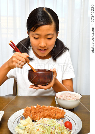 Girl eating tonkatsu Girl eating tonkatsu 57545226