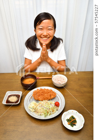 Girl eating tonkatsu Girl eating tonkatsu 57545227