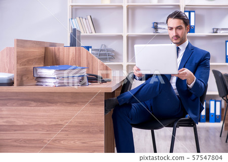 Young handsome businessman working in the office 57547804