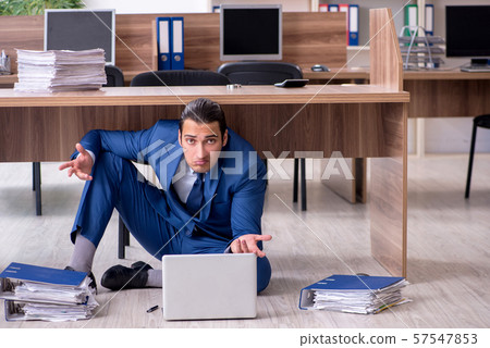 Young male employee and too many work in the office Young male employee and too many work in the office 57547853