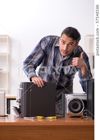 Young engineer repairing musical hi-fi system 57548586