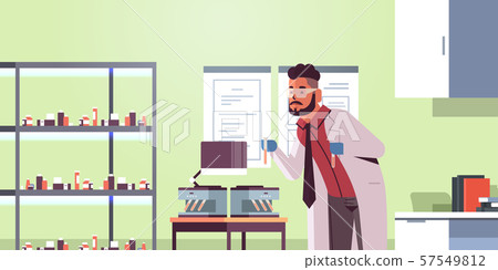 scientist holding test tubes with blood samples man in uniform using analyzer medical machine scientist holding test tubes with blood samples man in uniform using analyzer medical machine 57549812