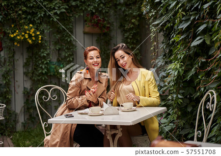 A middle-aged red-haired woman in a brown coat A middle-aged red-haired woman in a brown coat 57551708