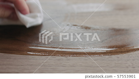 woodworker applying oil finish to black walnut board 57553901