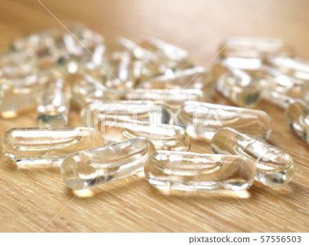 Supplement capsule spread on a wooden table 57556503