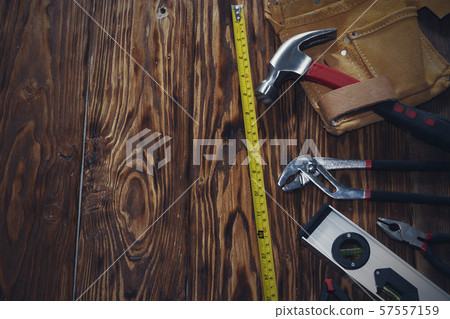 Close up tools on a wooden background. Close up tools on a wooden background. 57557159