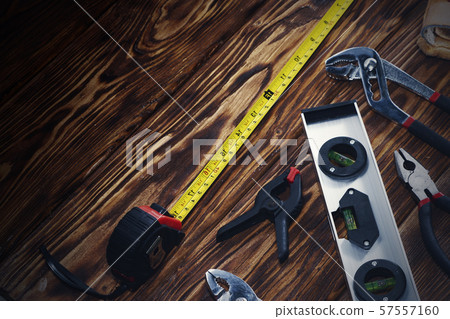 Close up tools on a wooden background. 57557160