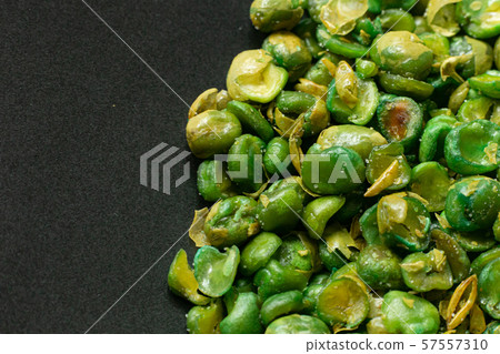 The salted peas on black Ceramic Plate close up image. The salted peas on black Ceramic Plate close up image. 57557310