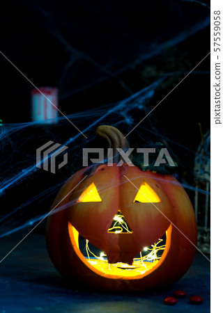 Halloween pumpkin with scary on the window at night Halloween pumpkin with scary on the window at night 57559058