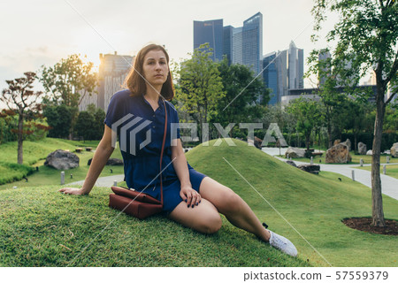 Beauty young woman sitting on the grass Portrait of girl outdoors 57559379