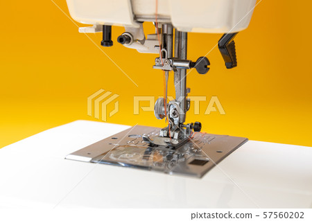 Sewing machine on table in tailor's workshop Sewing machine on table in tailor's workshop 57560202