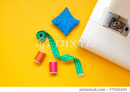 Close up foot of sewing machine and handcraft Close up foot of sewing machine and handcraft 57560204