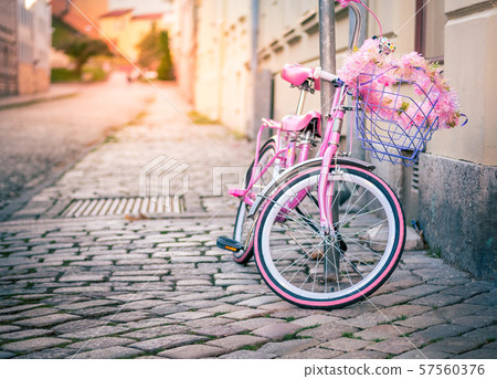 Pink kids bicycle with shopping basket Pink kids bicycle with shopping basket 57560376