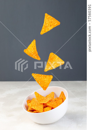 Cheesy tortilla chips or nacho levitate Cheesy tortilla chips or nacho levitate 57560391