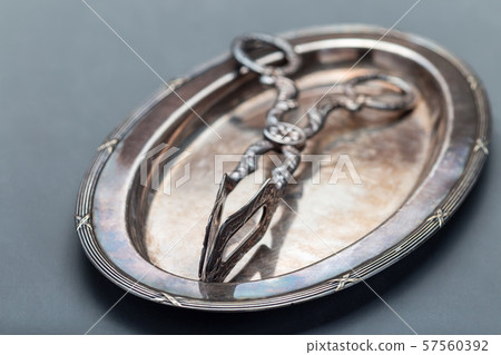 Empty vintage style metal dish and sugar tongs 57560392