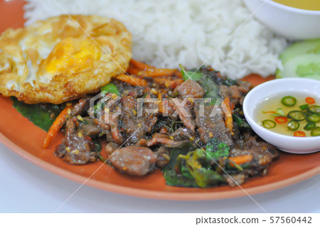 stir-fried beef with fried egg, holy basil and stir-fried beef with fried egg, holy basil and 57560442
