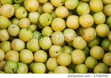 Background of fresh green plums on the market. 57560495