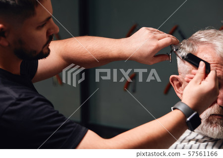 young talented barber doing new modern hairstyle young talented barber doing new modern hairstyle 57561166