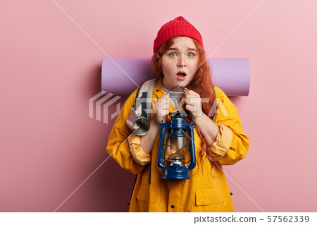 Shocked ginger funny hitch hiker carrying backpack 57562339