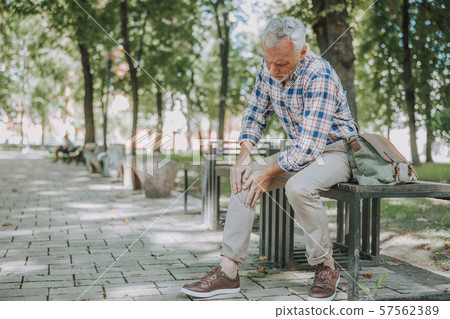 Aged man having sudden ache in his knee stock photo 57562389