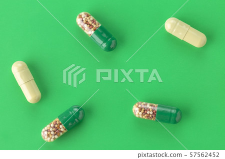various capsules with antibiotics on a green various capsules with antibiotics on a green 57562452