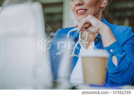 Smiling woman with coffee and spectacles stock photo Smiling woman with coffee and spectacles stock photo 57562789