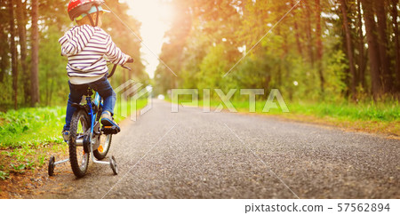 a child on a bicycle in helmet 57562894